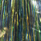 Close-up of metallic tinsel with green, gold, and blue colors.