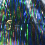 Close-up of tinsel with blue, green, and multicolor strands.