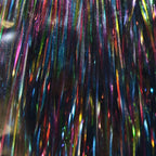 Multicolored tinsel strands on a black background
