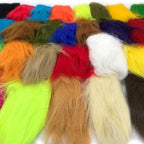 A collection of craft fur in various colors used for fly tying in fishing.