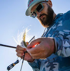 An ergonomic yellow powder-coated comb with a stainless steel shaft and teeth, designed for fly tying in fishing.