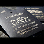 Black tag with white text and branding for OPST (Olympic Peninsula Skagit Tacos) on a gray surface.