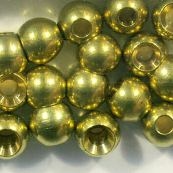 Gold beads for fly tying on a white background