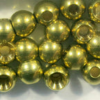 Gold beads for fly tying on a white background