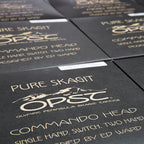 Close-up of black OPSC (Olympic Peninsula Skagit Cacti) packaging with gold text and logo.
