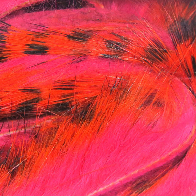 Close-up of pink and orange Hareline Tiger Barred 1/8” Rabbit Strips