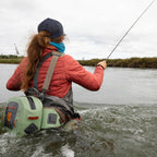 Angler wearing a Fishpond Thunderhead Submersible Lumbar Pack in yucca color