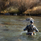 Angler wearing a Fishpond Thunderhead Submersible Lumbar Pack in gray color