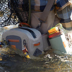 Angler wearing a Fishpond Thunderhead Submersible Lumbar Pack in gray color