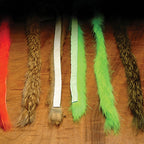 Set of colorful Hareline 1/4" Magnum Rabbit Strips on a brown background