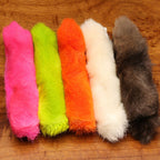 Set of colorful Hareline Para Feet on a wooden surface