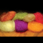 Colorful fluffy polar dub balls on a wooden surface
