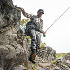 Man fishing on rocky terrain wearing Simms MEN's G3 Guide Stockingfoot Waders
