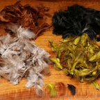 Hareline Premium Hungarian Partridge feathers in various colors on a wooden surface