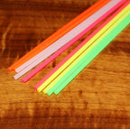 Colorful straws on a wooden surface