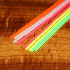 Colorful straws on a wooden surface