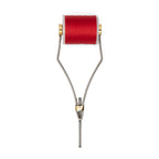 A stainless steel bobbin used for fly tying in fishing, with adjustable parts and gold-colored accents.
