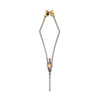A stainless steel bobbin used for fly tying in fishing, with adjustable parts and gold-colored accents.