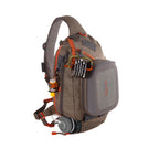 A brown and gray Fishpond Summit Sling Pack 2.0 with orange trim, featuring multiple pockets and exterior attachment points, designed for fishing gear.