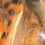 Close-up of orange, black, and brown Hareline Tiger Barred 1/4" Magnum Rabbit Strips