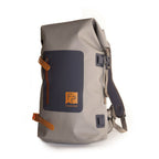 A gray Fishpond Wind River Roll-Top Backpack with orange straps and zipper closure.