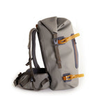 A gray Fishpond Wind River Roll-Top Backpack with orange straps and zipper closure.