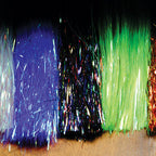 Colorful Hedron Flashabou tinsel strands in blue, green, and multicolor on a dark background
