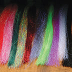 Colorful Hareline Krystal Flash strands on a dark background