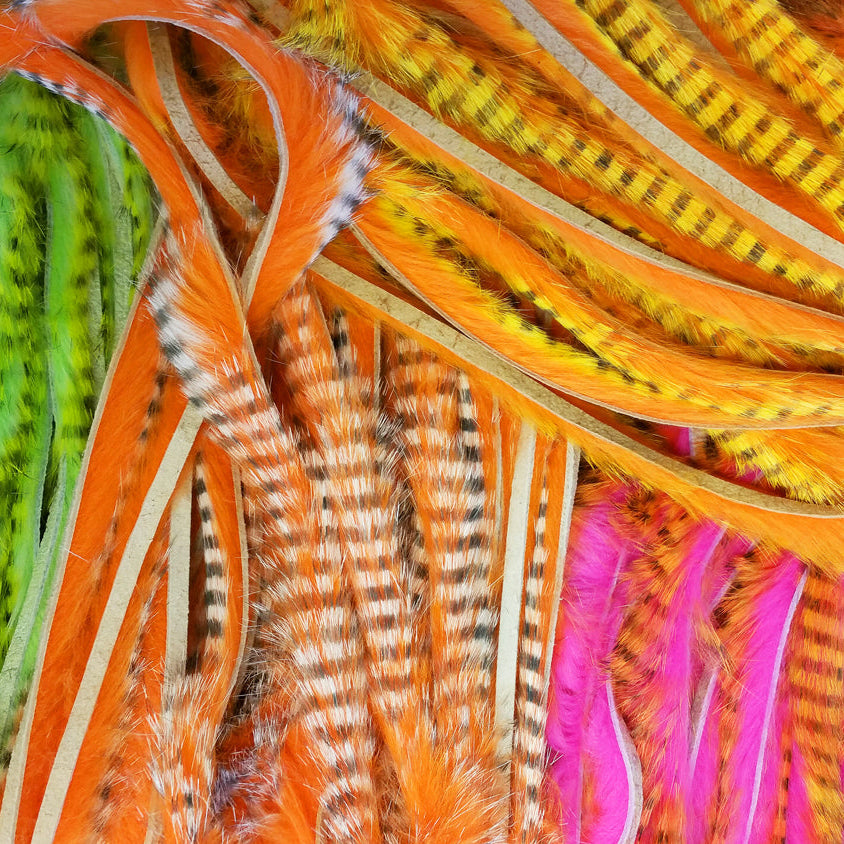 Close-up of colorful Hareline Tiger Barred 1/4" Magnum Rabbit Strips in various patterns and colors.